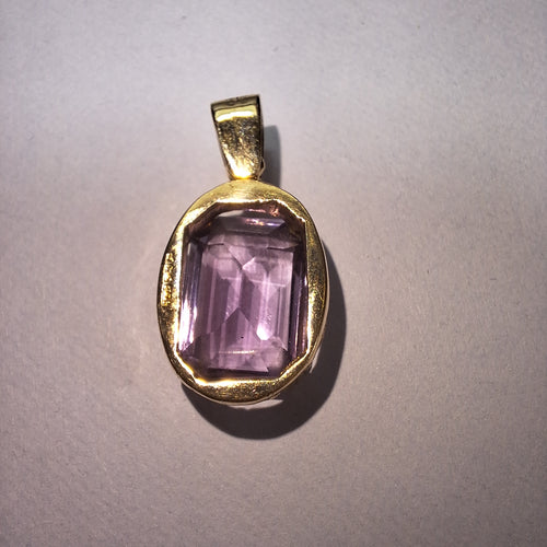 Large Amethyst held in a 9ct yellow gold pendant