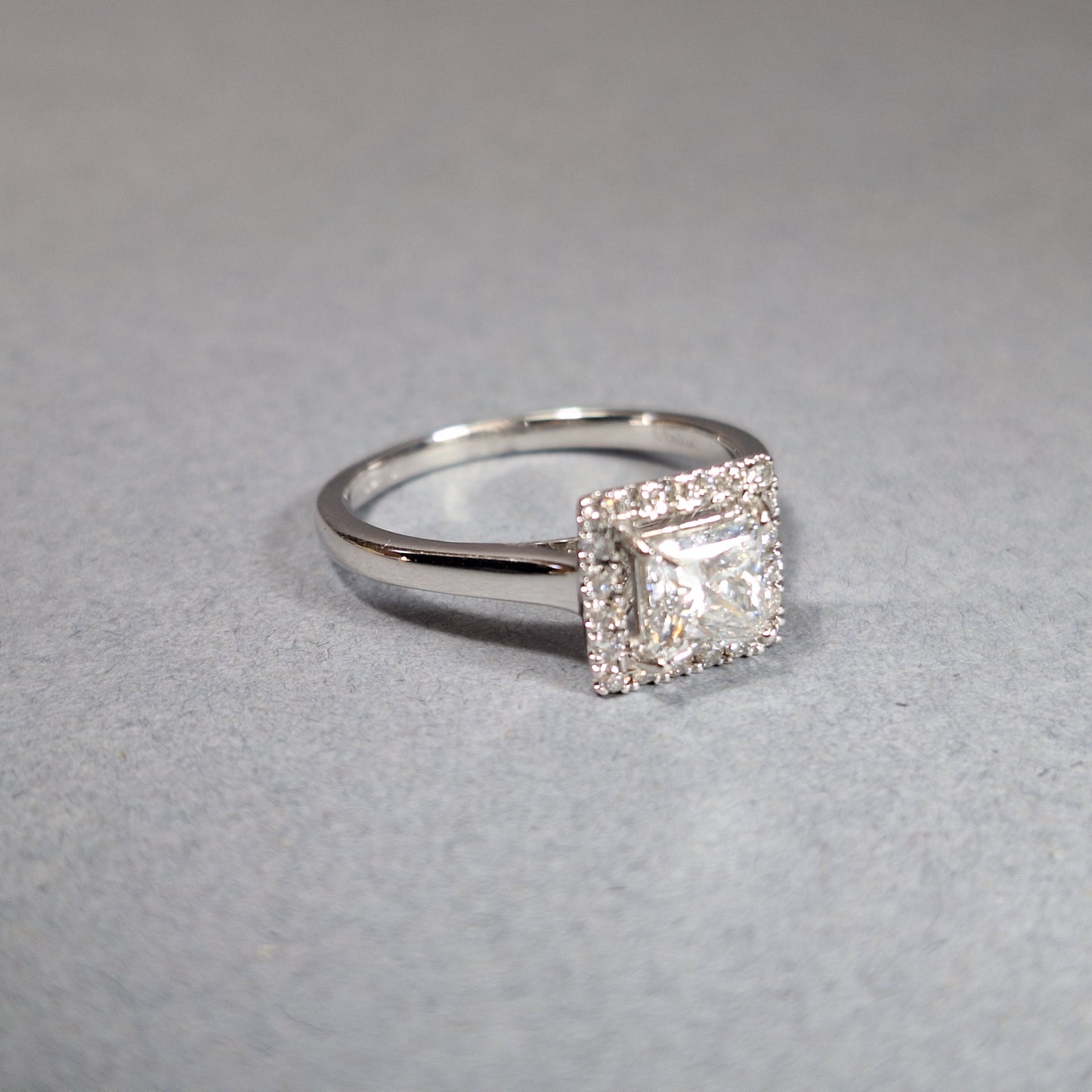 New Princess Cut 0.72ct Lab Grown Diamond with twenty round brilliant Cut Lab Grown Diamonds around the edge all on a Platinum Band