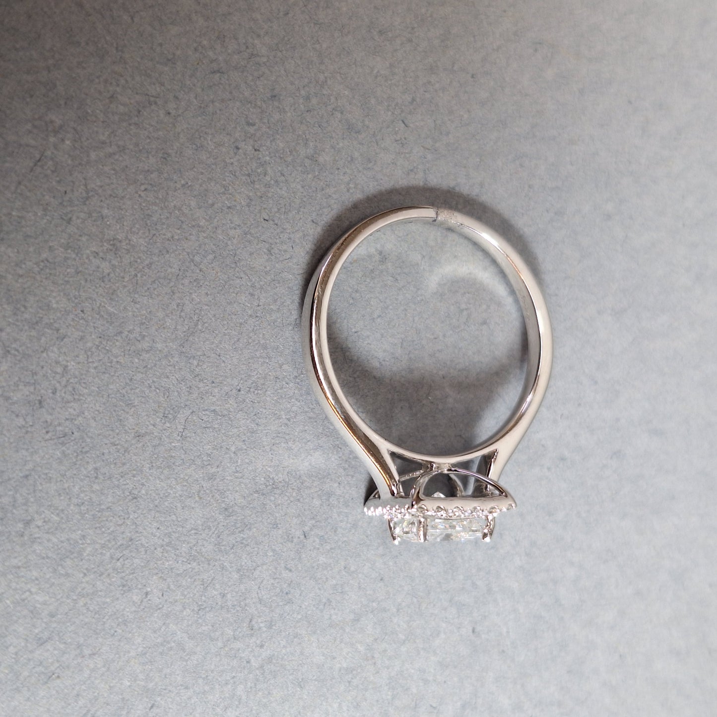 New Princess Cut 0.72ct Lab Grown Diamond with twenty round brilliant Cut Lab Grown Diamonds around the edge all on a Platinum Band