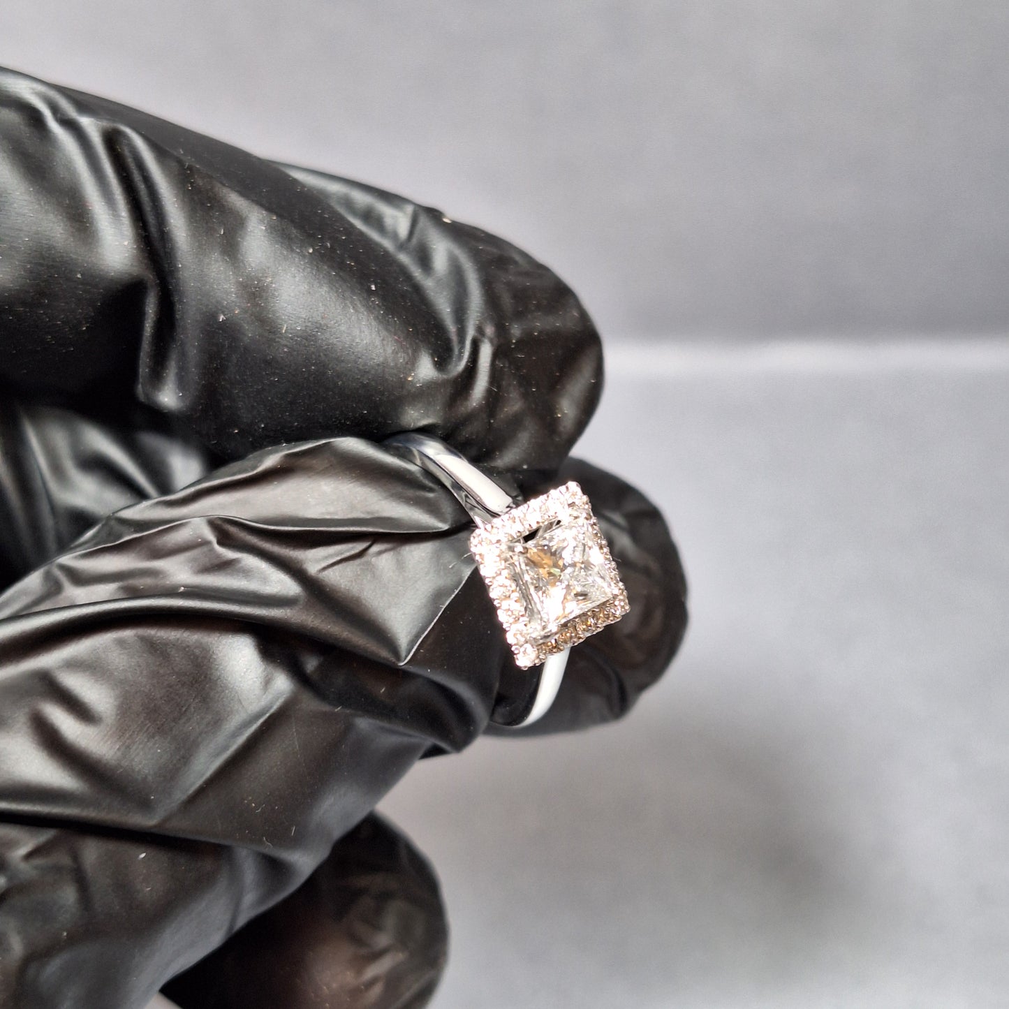 New Princess Cut 0.72ct Lab Grown Diamond with twenty round brilliant Cut Lab Grown Diamonds around the edge all on a Platinum Band