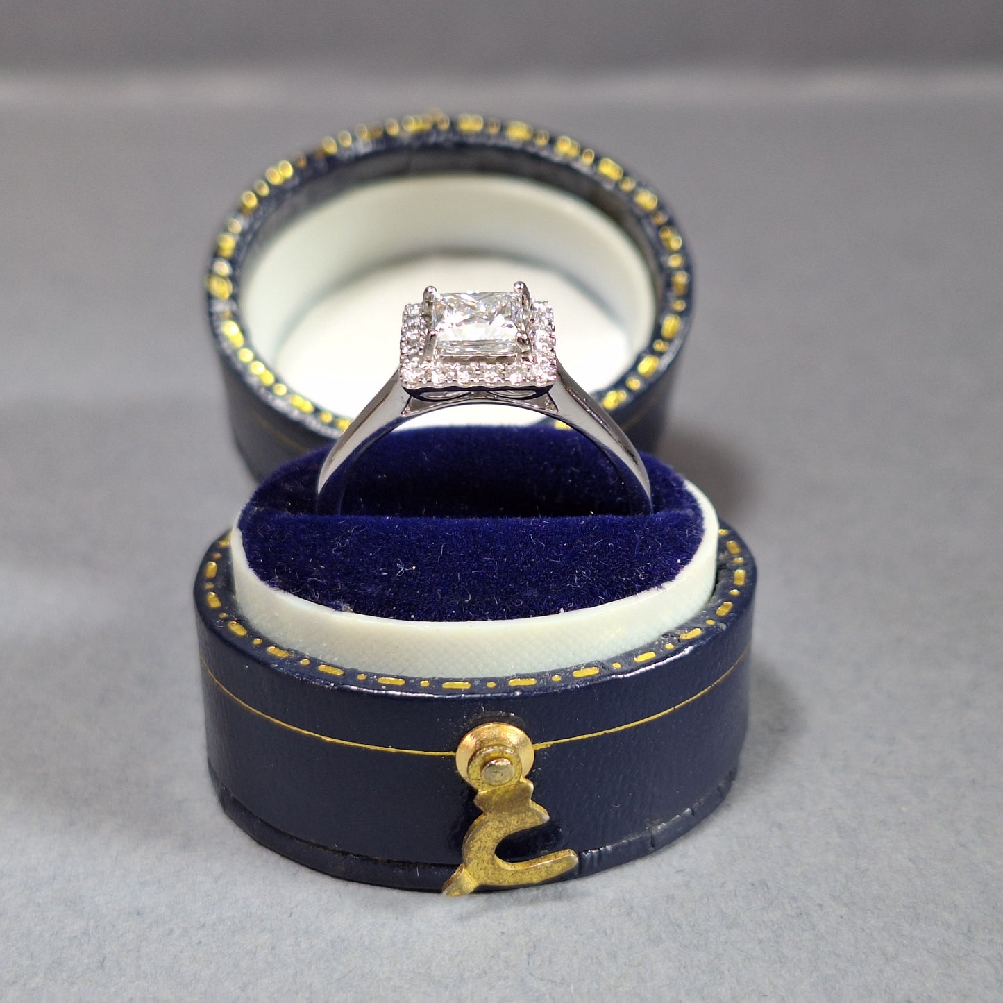 New Princess Cut 0.72ct Lab Grown Diamond with twenty round brilliant Cut Lab Grown Diamonds around the edge all on a Platinum Band