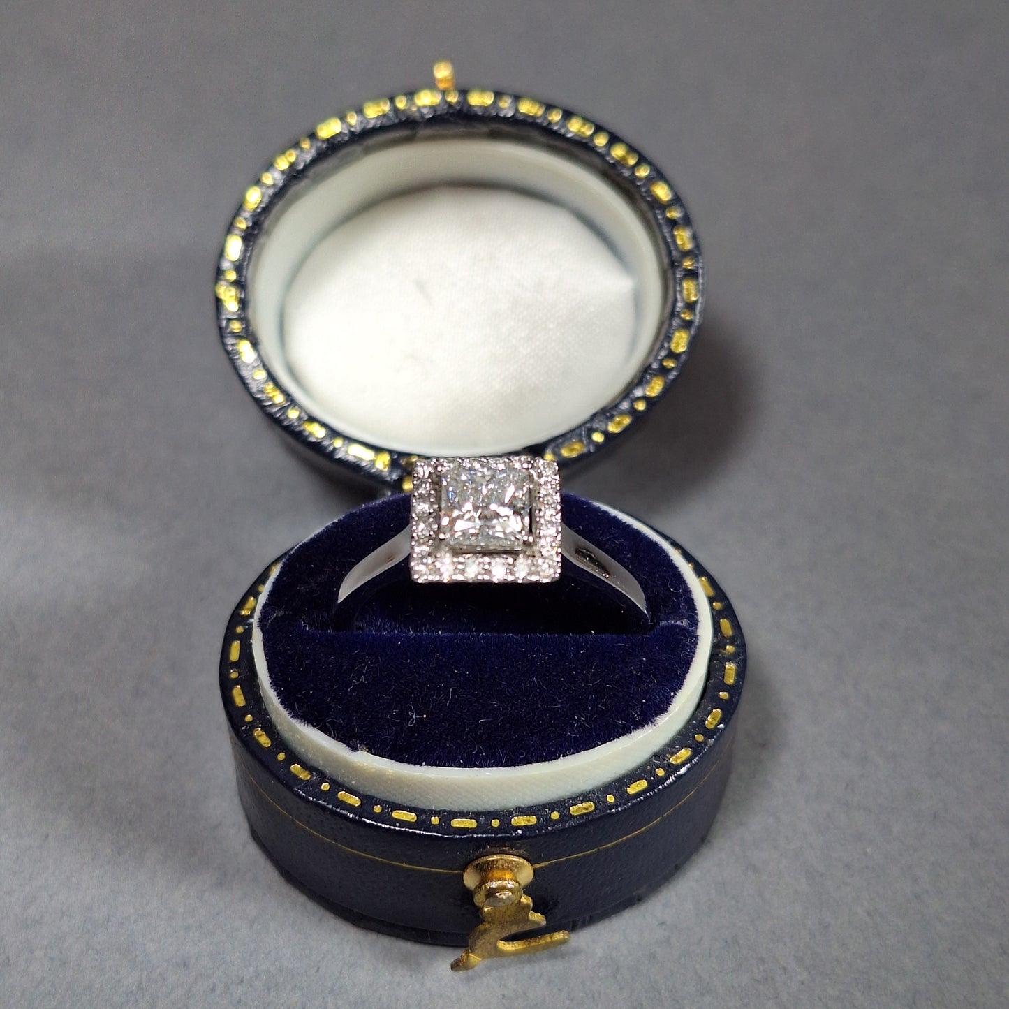 New Princess Cut 0.72ct Lab Grown Diamond with twenty round brilliant Cut Lab Grown Diamonds around the edge all on a Platinum Band