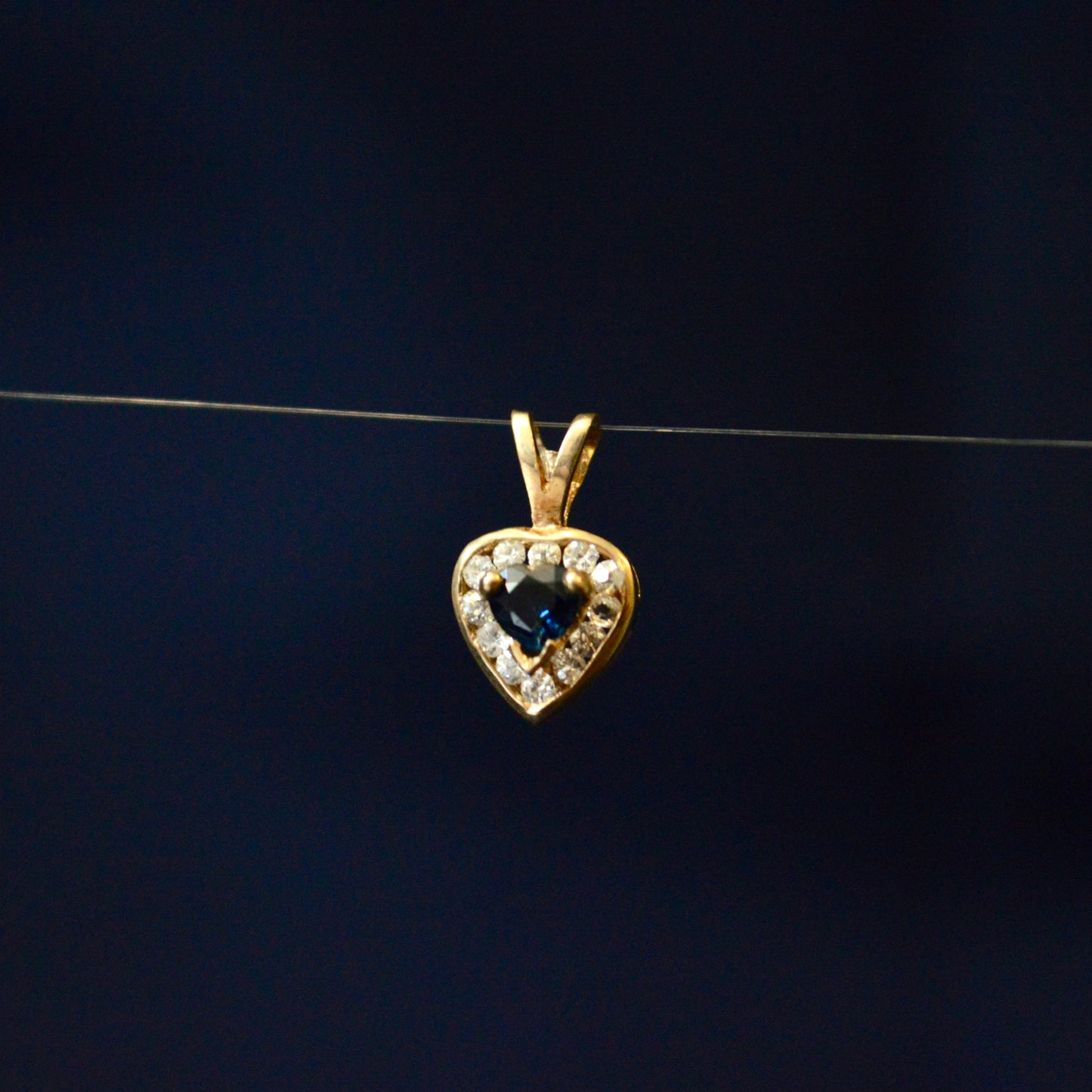 9ct Yellow Gold Sapphire style pendant surrounded with cubic zirconia