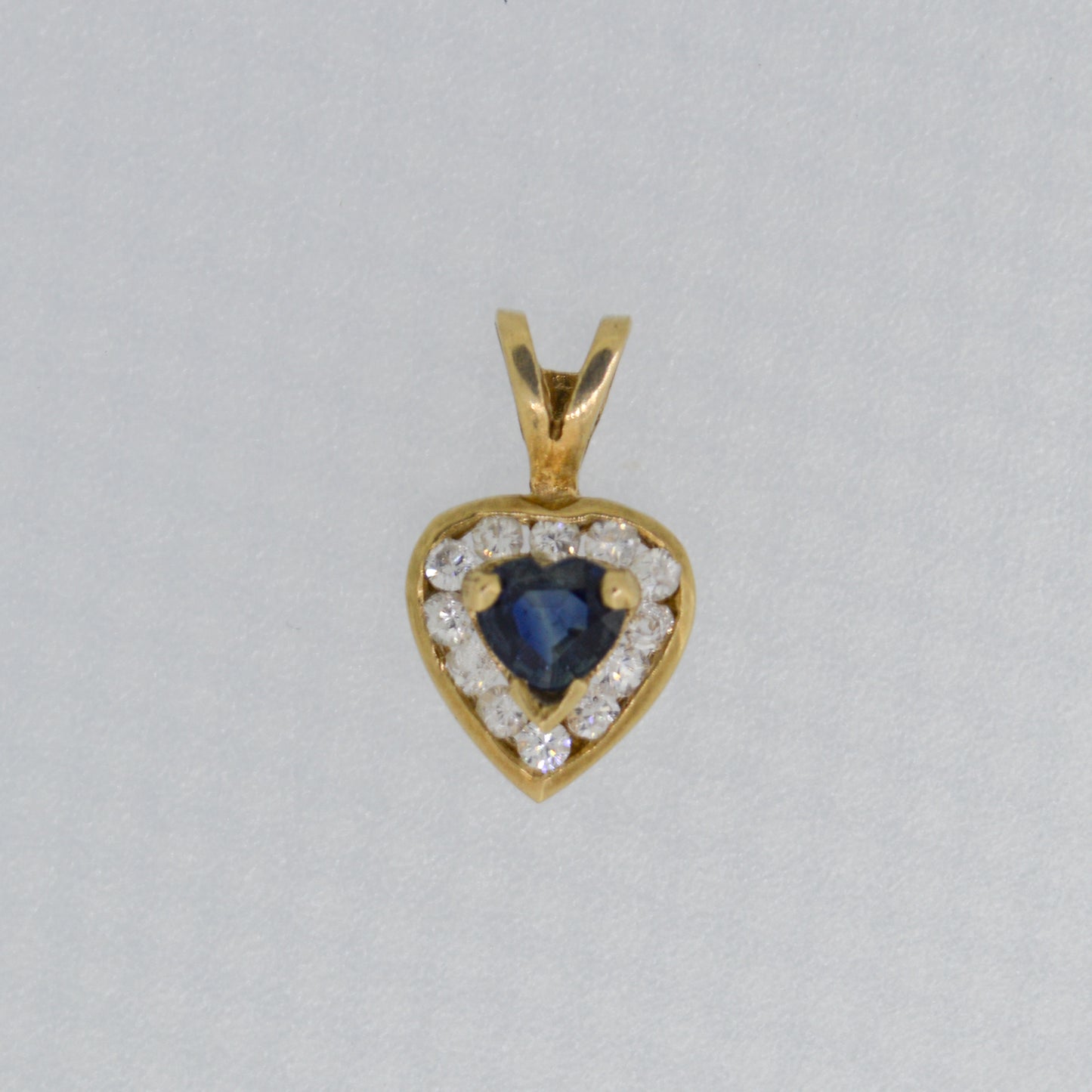 9ct Yellow Gold Sapphire style pendant surrounded with cubic zirconia