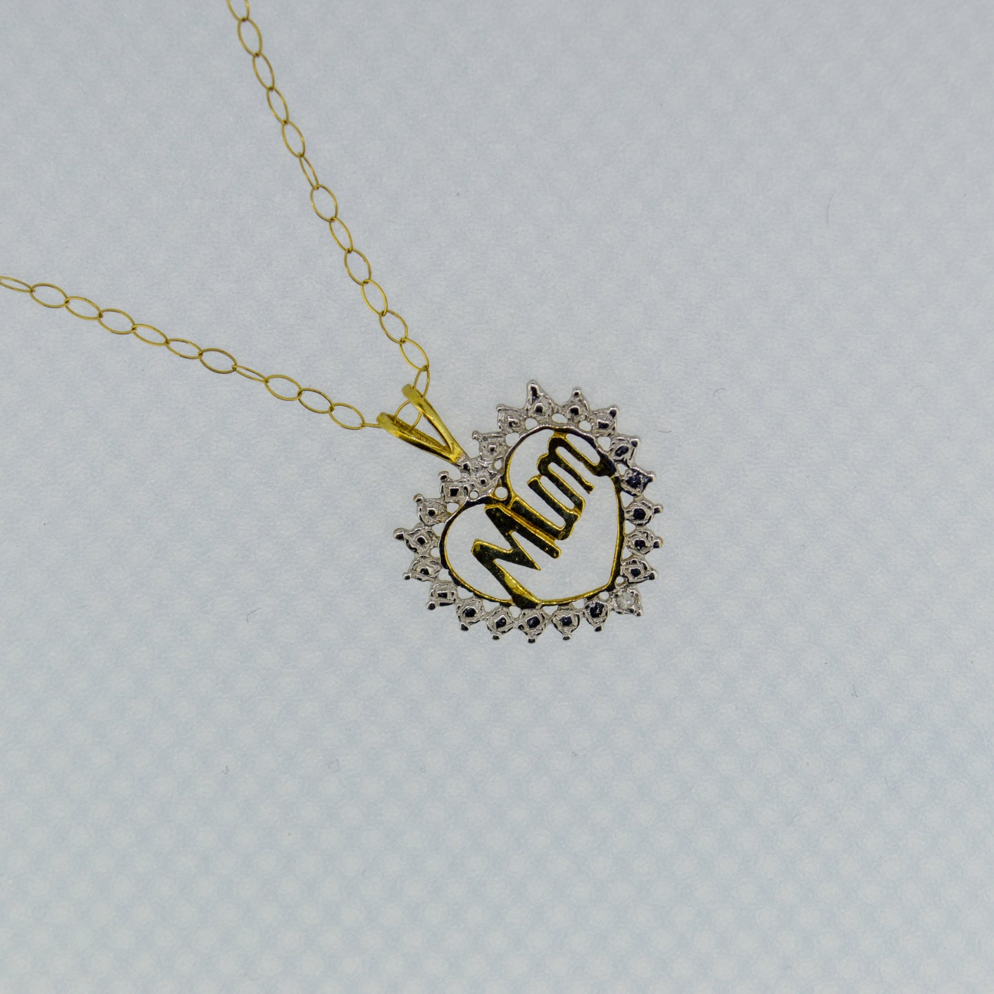 9ct Yellow gold 'Mum' pendant with White Gold detailing, on a trace chain