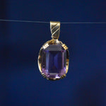 Large Amethyst held in a 9ct yellow gold pendant